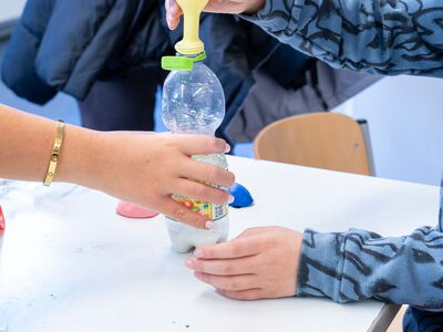 Ein Luftballon wird mit einer PET-Flasche aufgeblasen